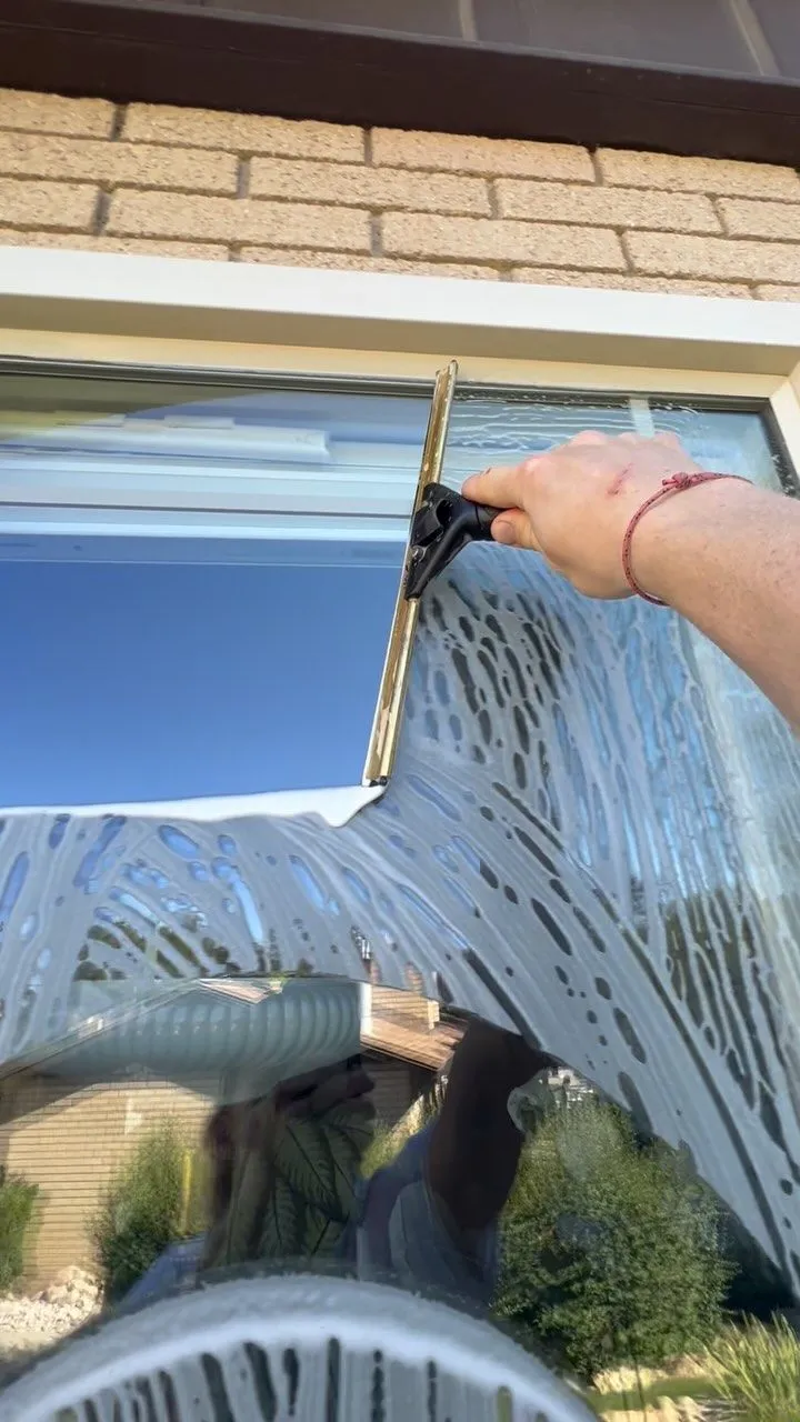 Squeegeeing an exterior window streak-free
